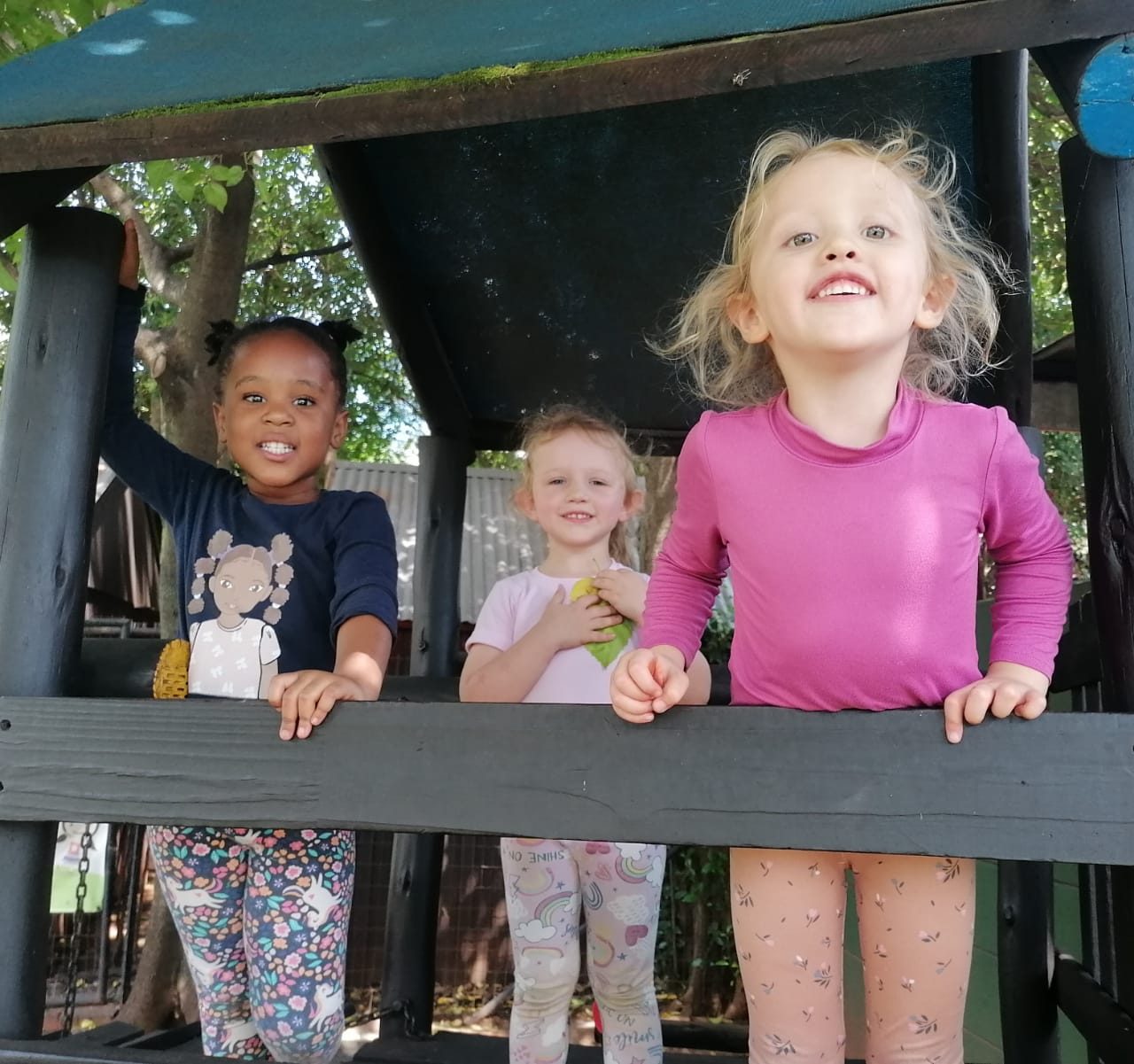 Children playing in the wooden playhouse in our garden